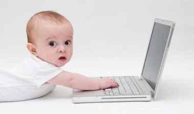Image of baby with a laptop.